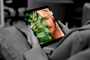 Close shot of hands holding a tablet/ipad showing Family & Professional Guardianship ebook cover